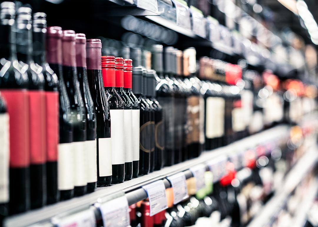 Bottles of wine on a shelf in a liquor store.