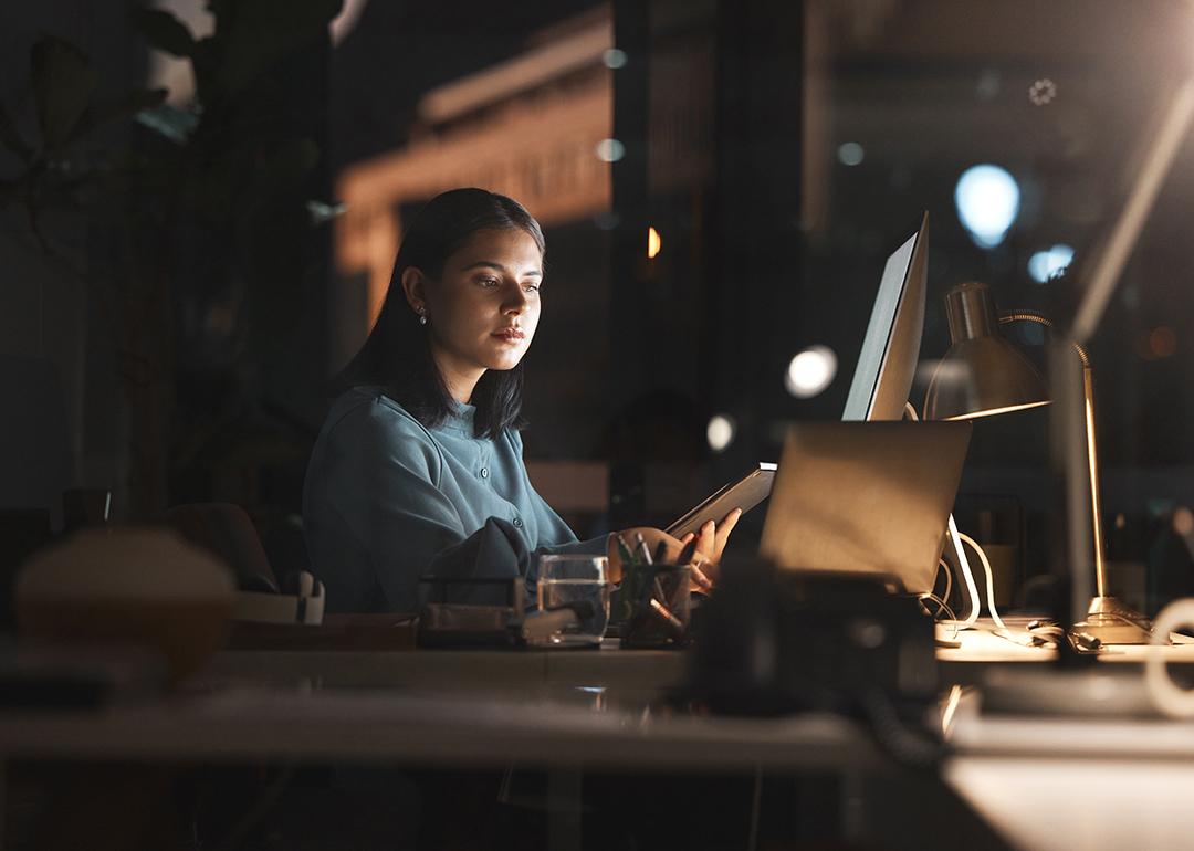 A businesswoman working in office at night.