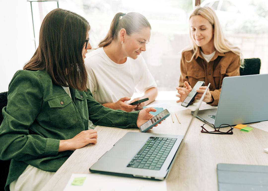 Three businesswomen in a meeting discussing marketing strategies.