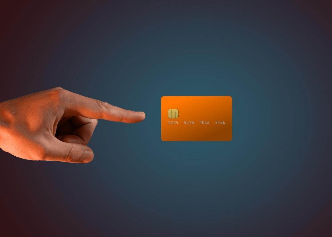 A hand levitating a credit card.