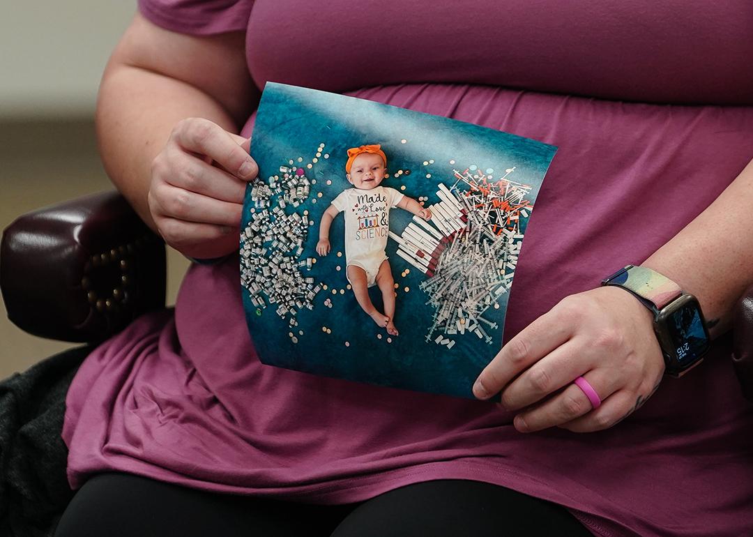 Elizabeth Goldman, an in-vitro fertilization patient at the University of Alabama at Birmingham, holds up a photo of her daughter who was born via the procedure.