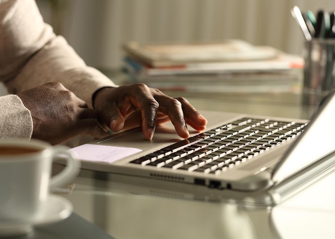 Close-up of a businessman using a laptop in the office at night.