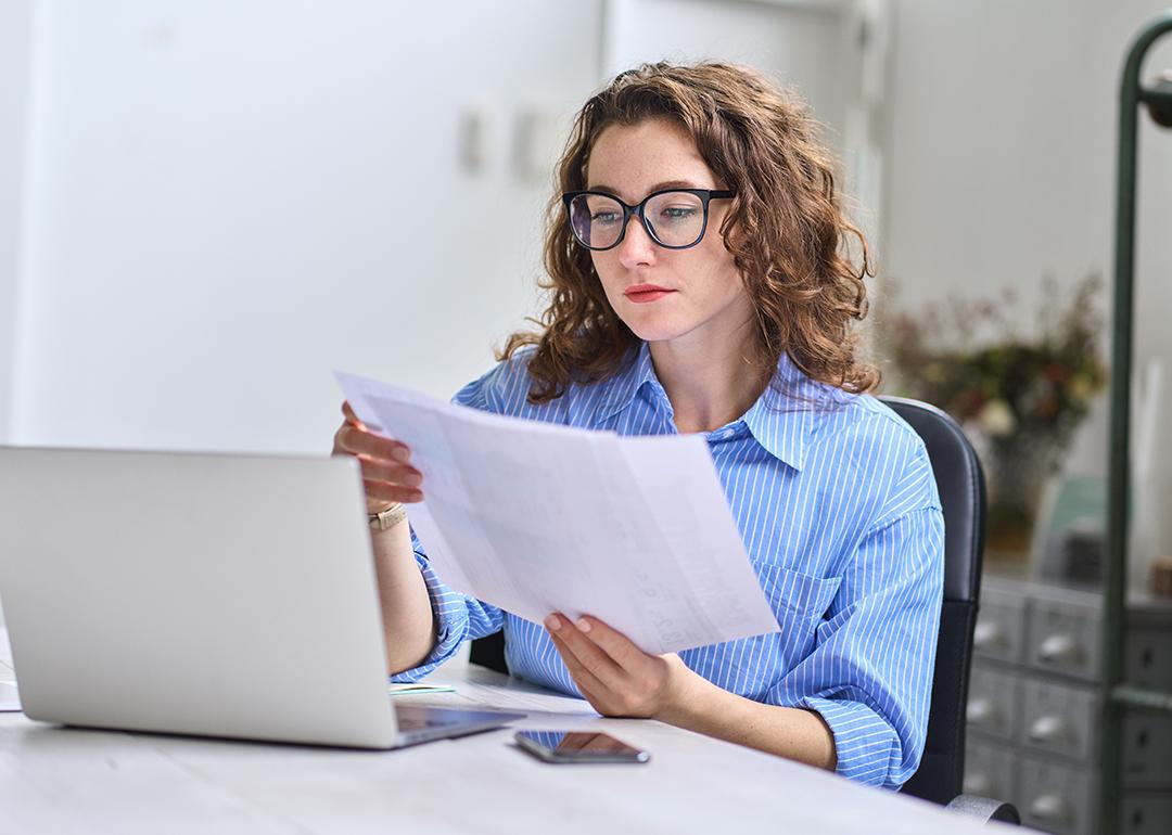 A young businesswoman reading audit reports.