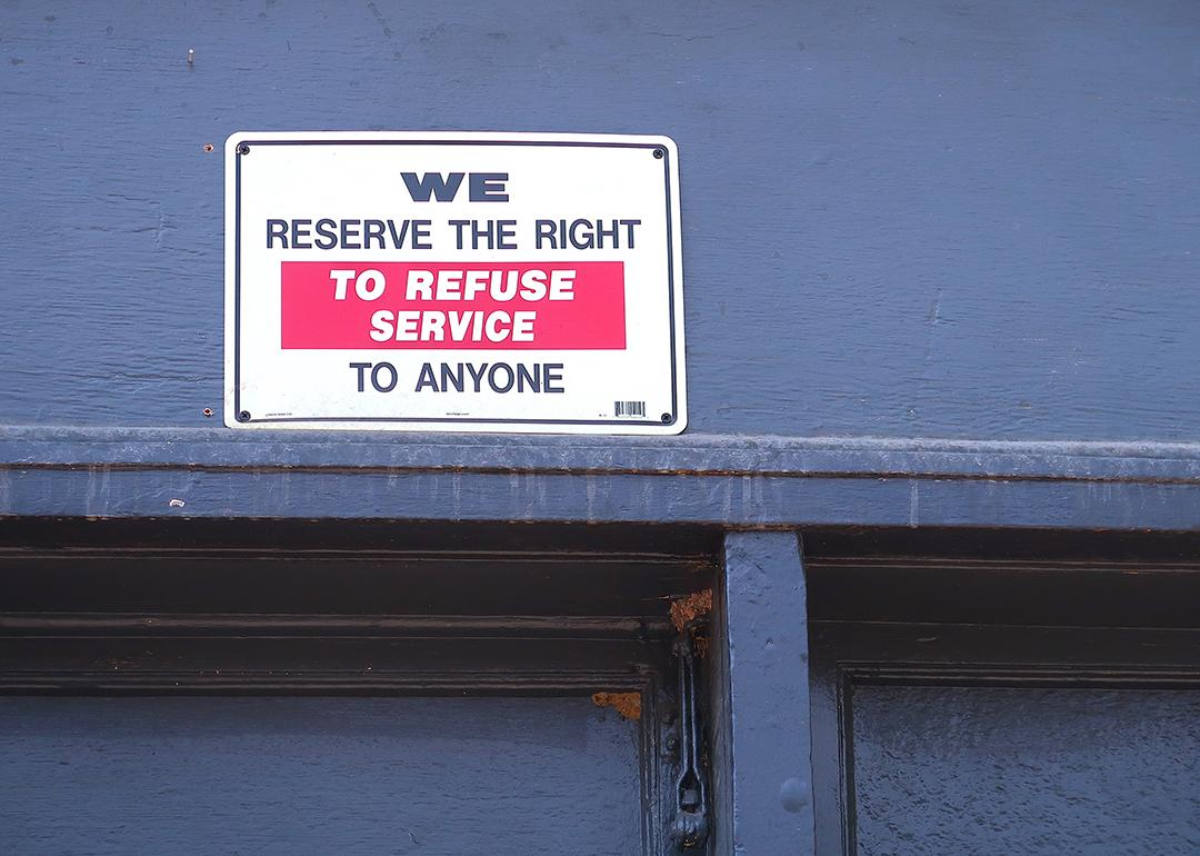 A "We reserve the right to refuse service to anyone" signage at a restaurant.