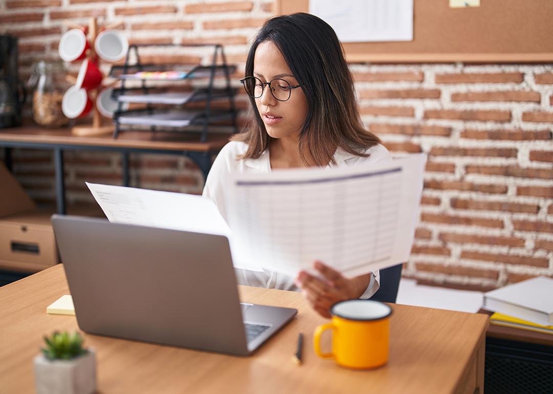 A female business worker looking at business documents.