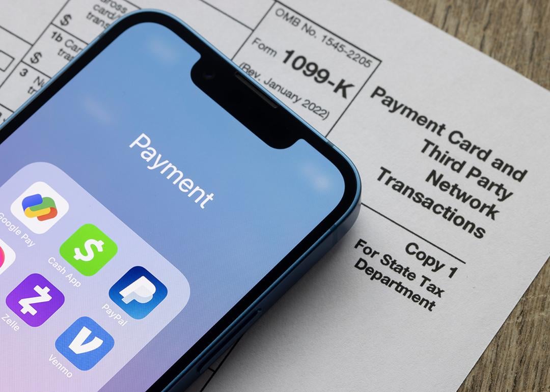 Payment apps on an iPhone and a Form 1099-K document.