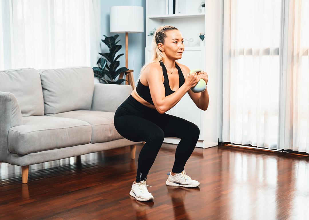 Woman at home in a leg day training session.