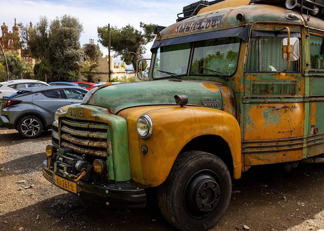 A vintage, old-timer school bus repurposed as a camper van.