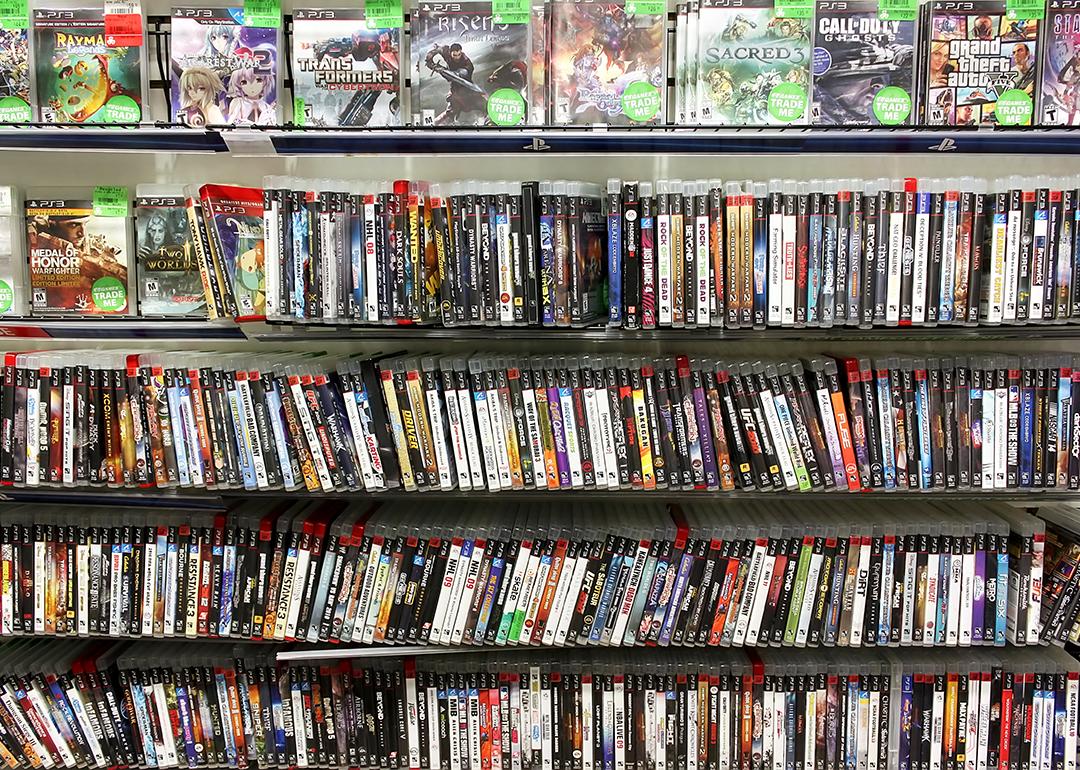 PlayStation game discs on display at a game store.