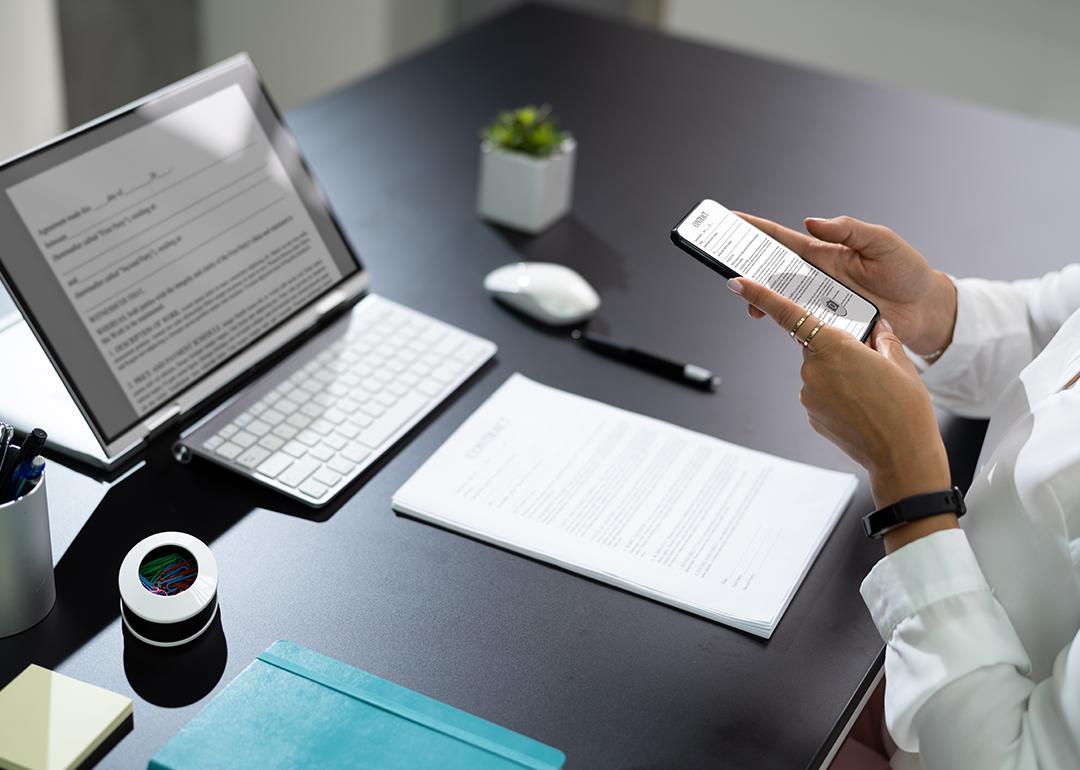 Employee at work manually scanning a document with a phone.