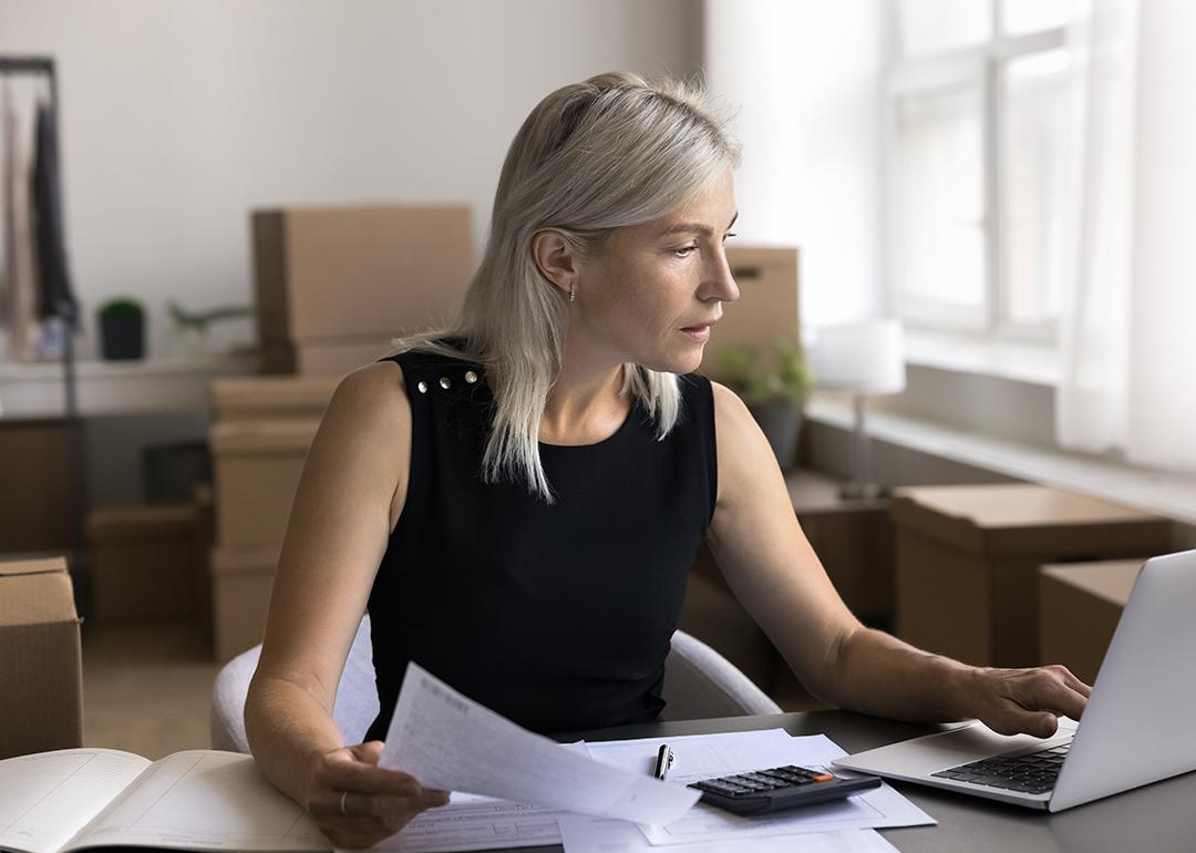 A female business owner reviewing documents in her office.