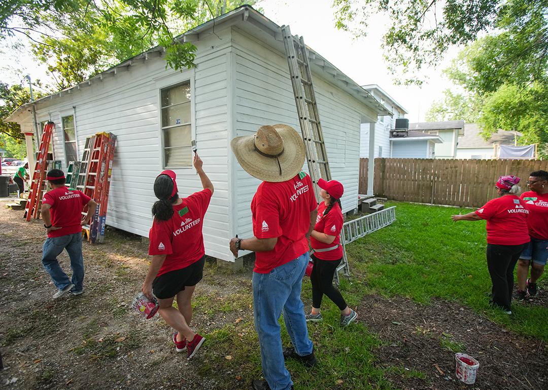 Volunteers from CITGO paint a home as part of a repairs initiative in Houston, Texas.