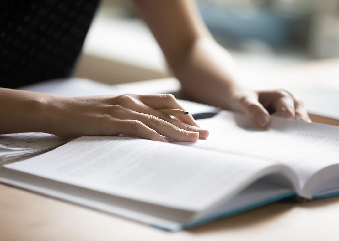 Student reading a book preparing for a college test.