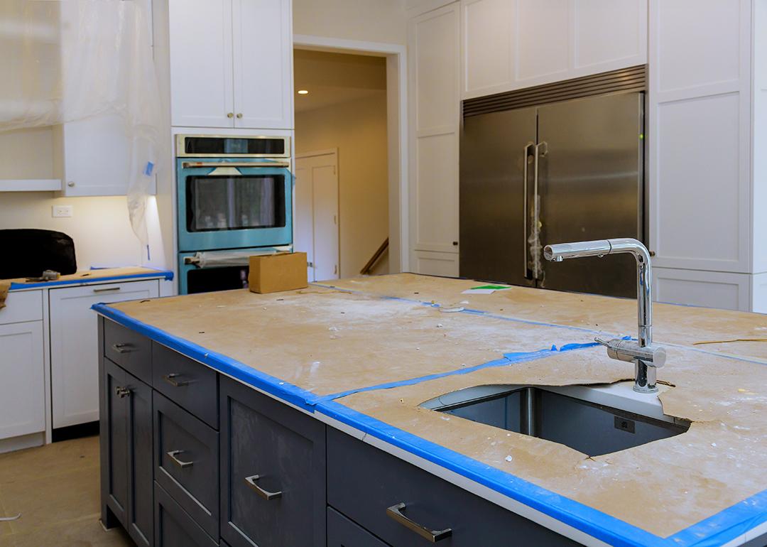 A modern kitchen with a focus on a countertop in progress of renovation.