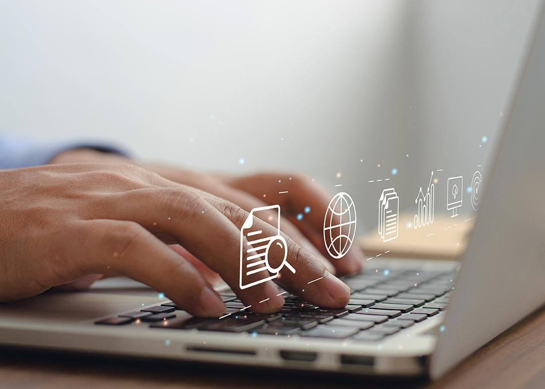 Content marketing graphics over hands typing on a laptop keyboard.