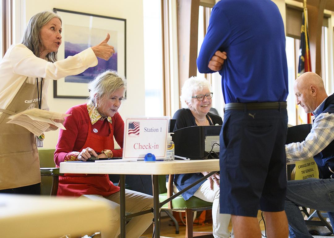 A voter receives a thumbs up from a poll worker after a successful check in at Biltmore Forest Town Hall during the 2024 U.S. election in Asheville, North Carolina. 