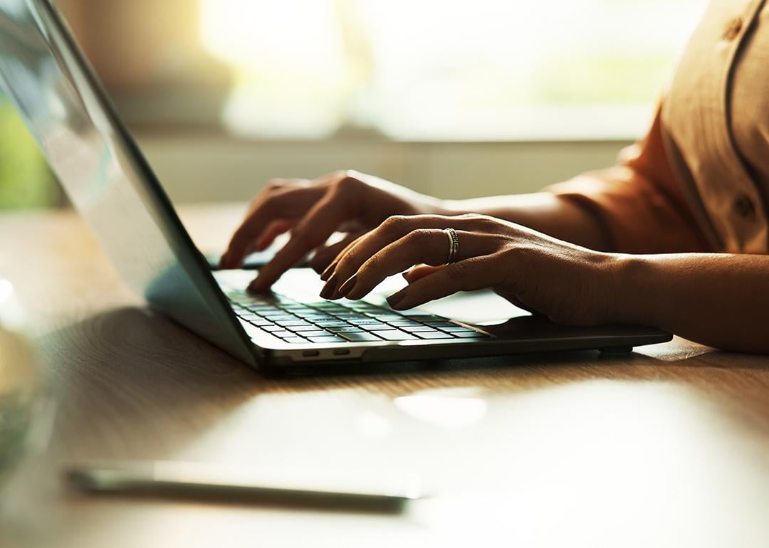 Freelancer typing on a laptop keyboard.