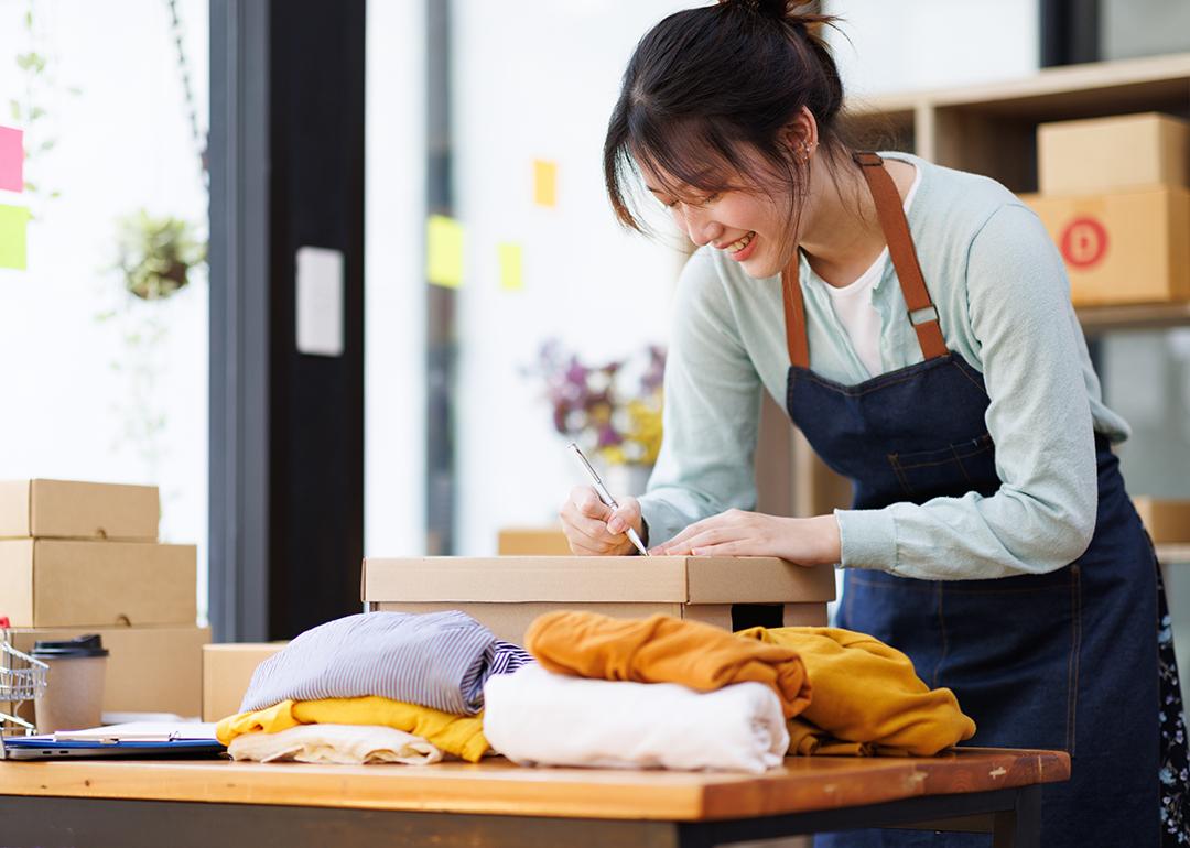A young female small business owner preparing an order for packaging.