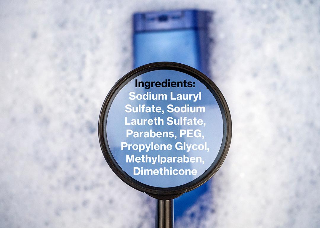 Chemical components listed on a magnifying glass over a shampoo bottle.