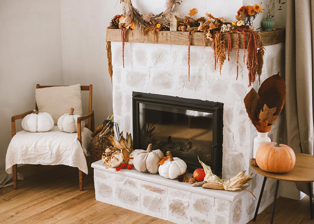 Fireplace corner of a living room with fall season decoration.