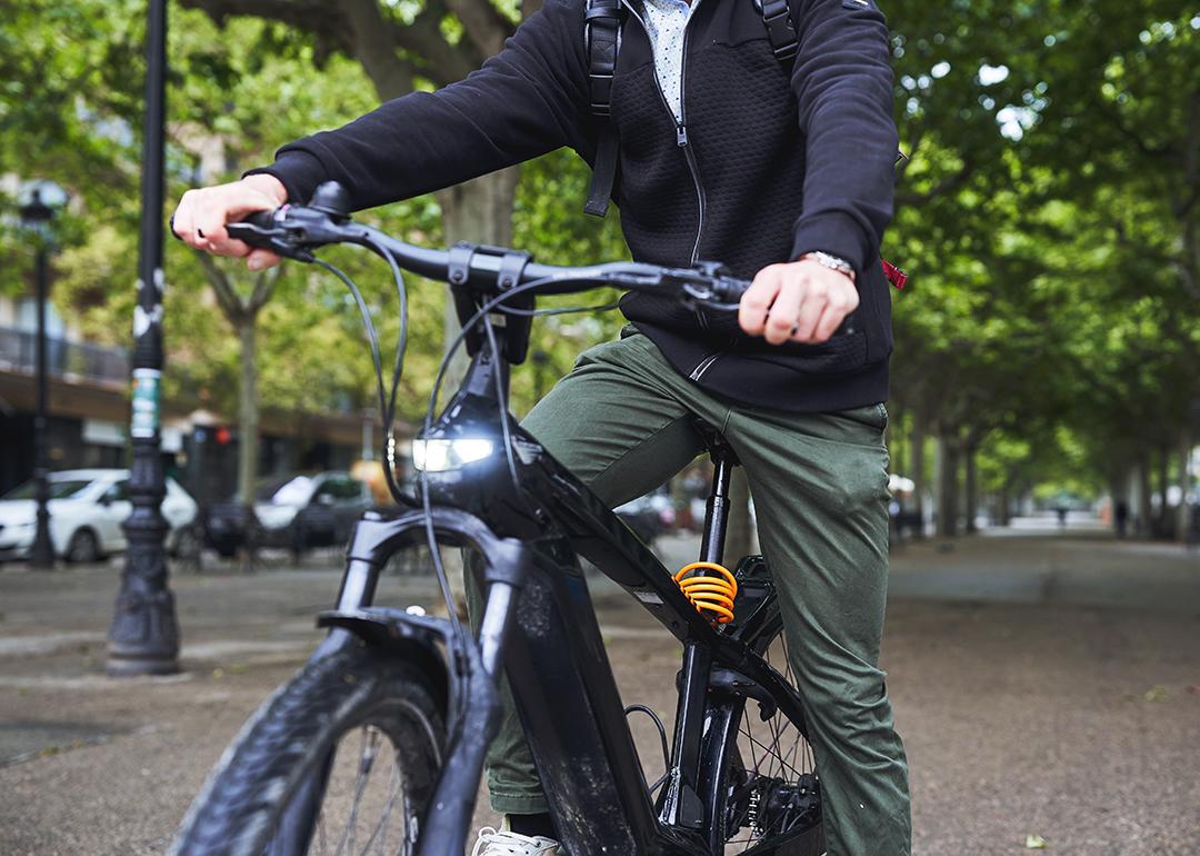 Man riding electric bicycle on a street.