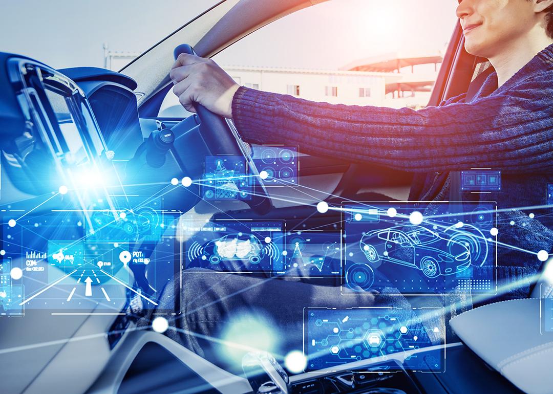 A driver inside a car illustrated with intelligent technology graphics.