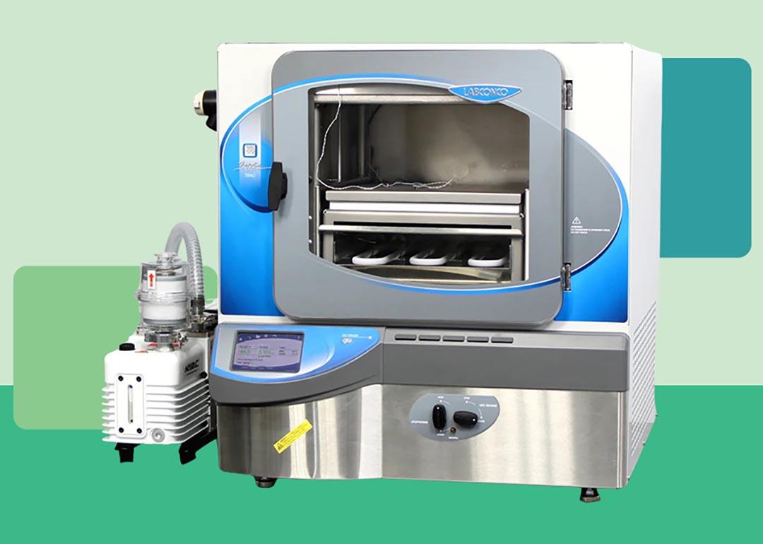 Photo of modern lab freeze dryer cut out against a stylized background of different shades of green blocks. 