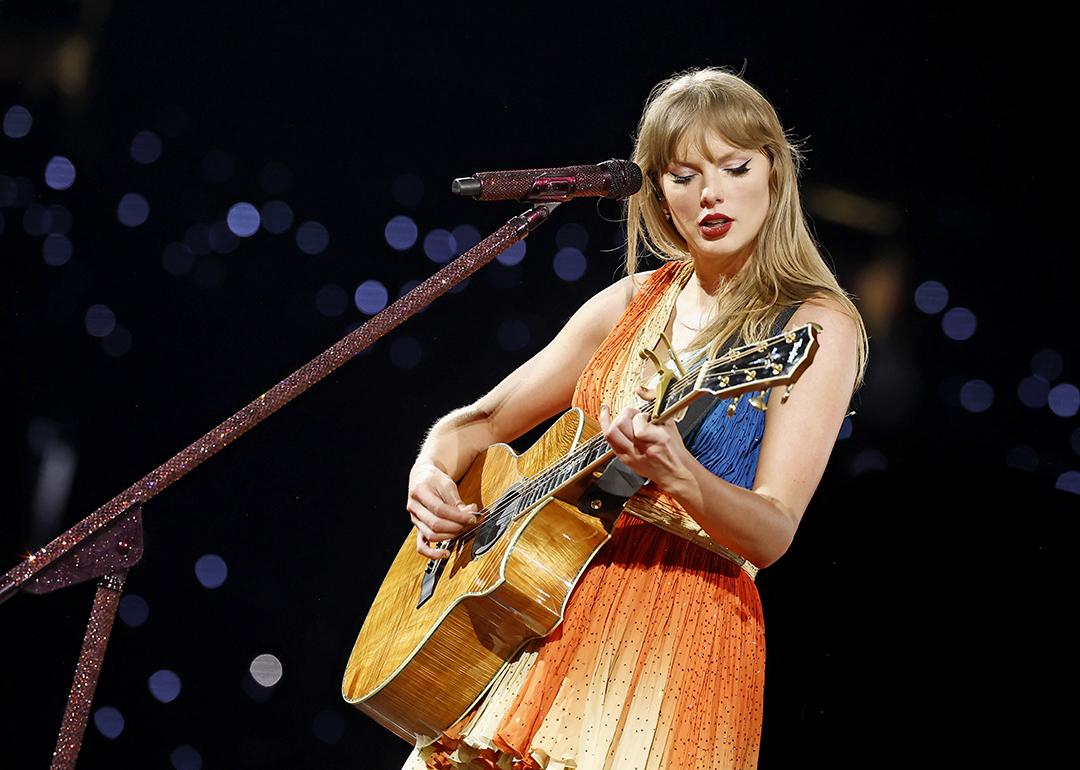 Taylor Swift performs on stage with her guitar during The Eras Tour at Rogers Centre in Toronto City, Ontario.