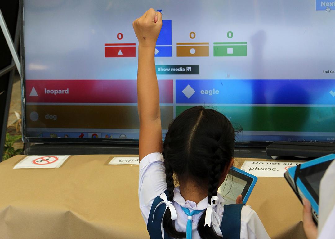 A young student celebrates a correct answer in an educational online game.