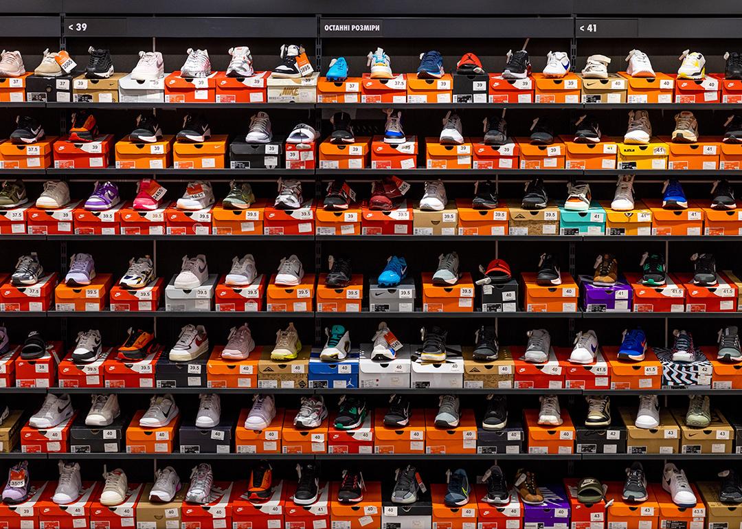 Various styles and models of Nike shoes neatly displayed on store shelves.