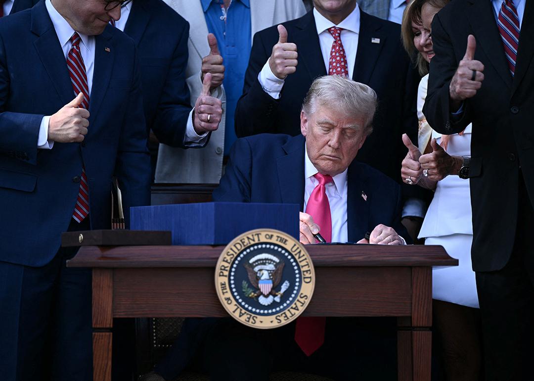 US President Donald Trump signs the 'Big Beautiful Bill Act' at the White House in Washington, DC on July 4, 2025.