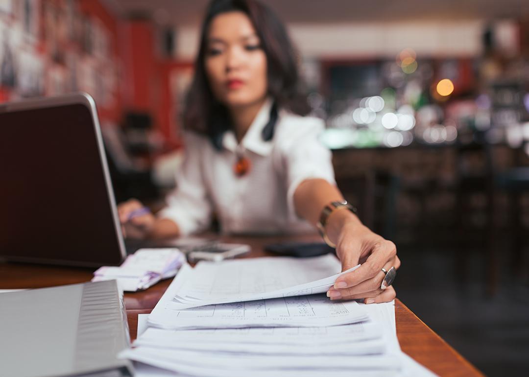 A female business owner reaches out for finance documents.