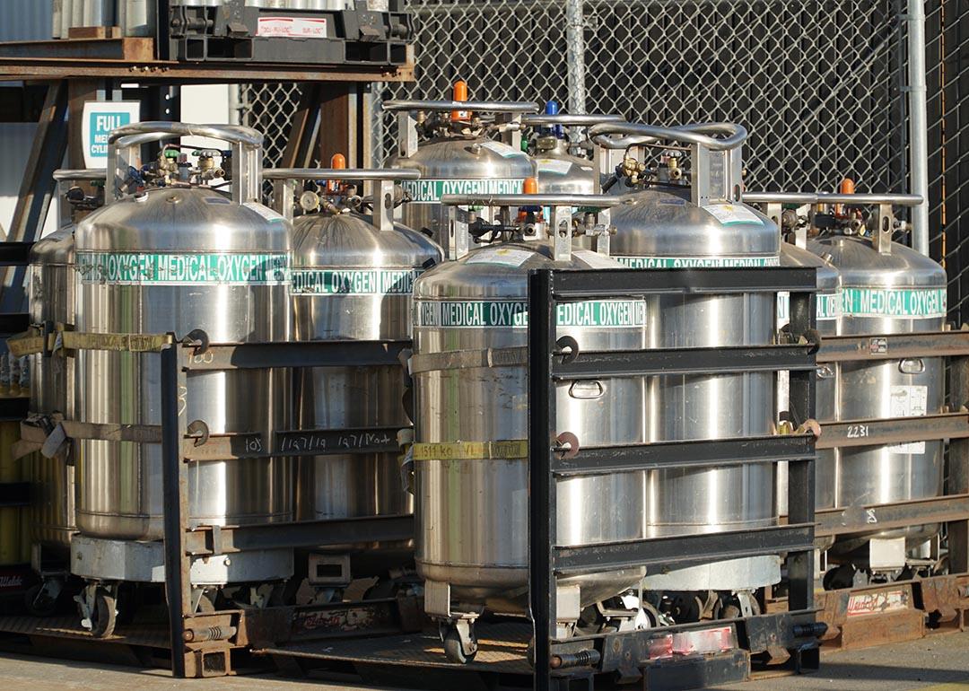  Industrial Oxygen cylinders waiting in racks outside filled and waiting to be put into use in Watsonville , California.