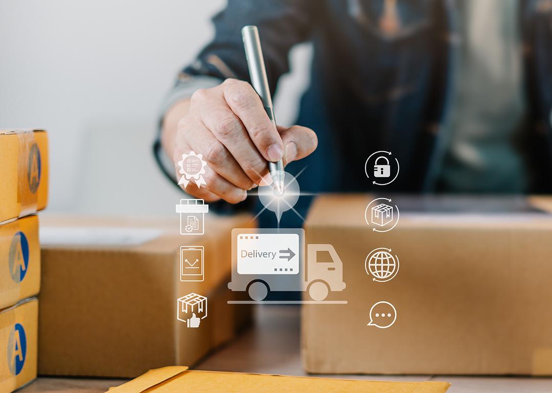 A logistics worker fulfills boxes of orders illustrated with a modern delivery system software graphics.