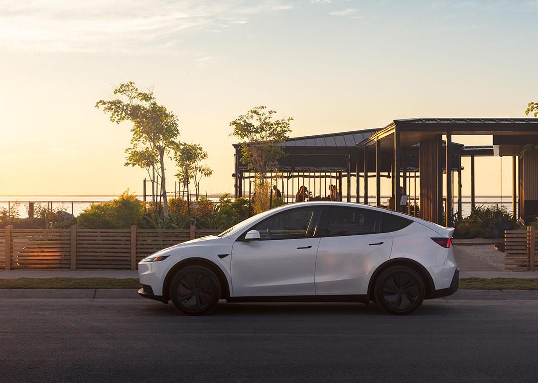 A white Tesla Model Y on the road.