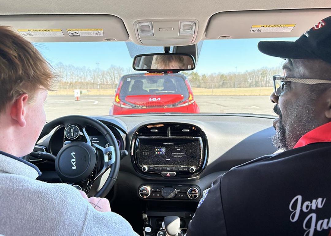 View from backseat of teen driver and expert behind the wheel. 