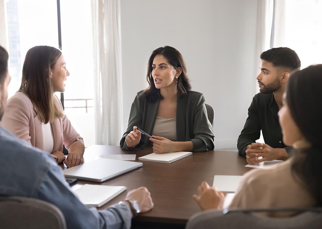 A business team seated around a conference table.