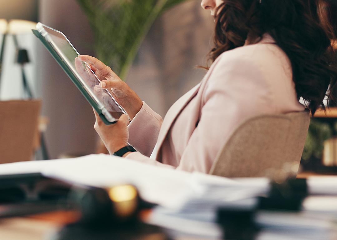 A female lawyer using a tablet in her home office.