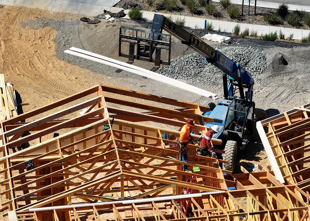 Aerial view of a home under construction with workers present on site in San Rafael, California.