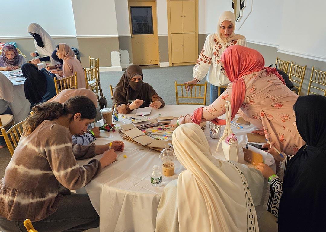 Women and girls of all ages gather for Sisters Self-Care Night at Muslim American Society Youth Center in Brooklyn, New York, a vibrant recurring event where creative activities and candid conversations help de-stigmatize seeking mental health support and weave faith and mental wellness together in community. 