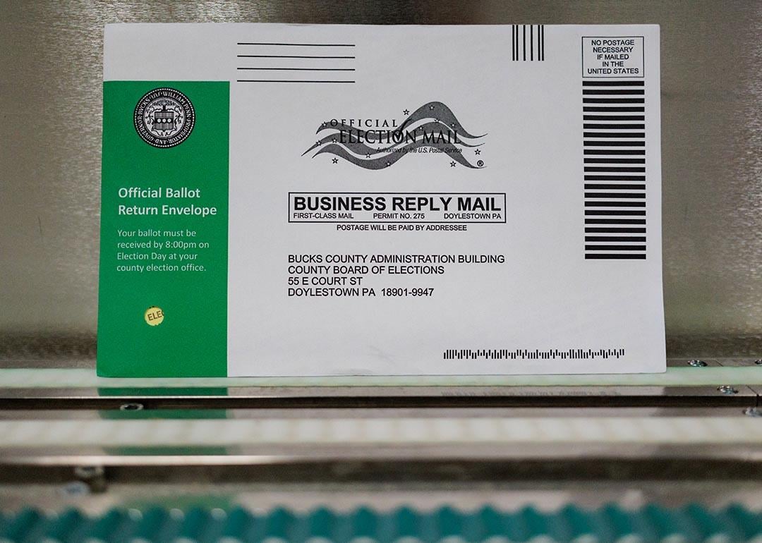 A Pennsylvania mail-in ballot with a green stripe on the envelope is displayed during a processing demonstration at the Board of Elections office on September 30, 2024 in Doylestown, Pennsylvania. 