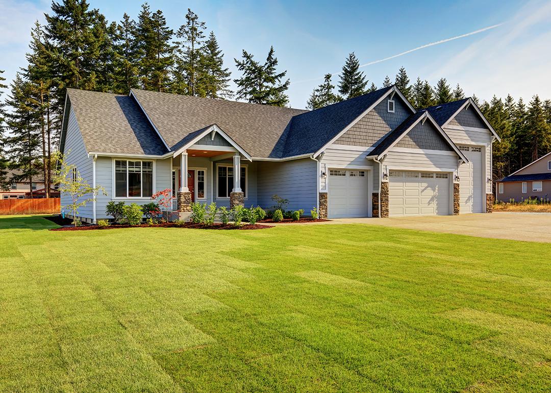 A modern, luxury home with a wide lawn in a Northwestern residential neighborhood in the US.
