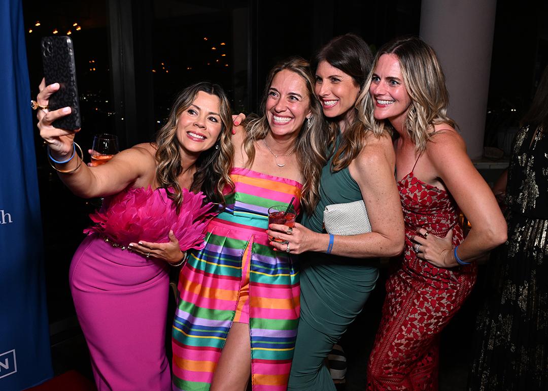 Marisa Peters (2nd L) poses for a selfie with guests at the BE SEEN Gala on June 7, 2025 at Harriet's Rooftop in Los Angeles, California.