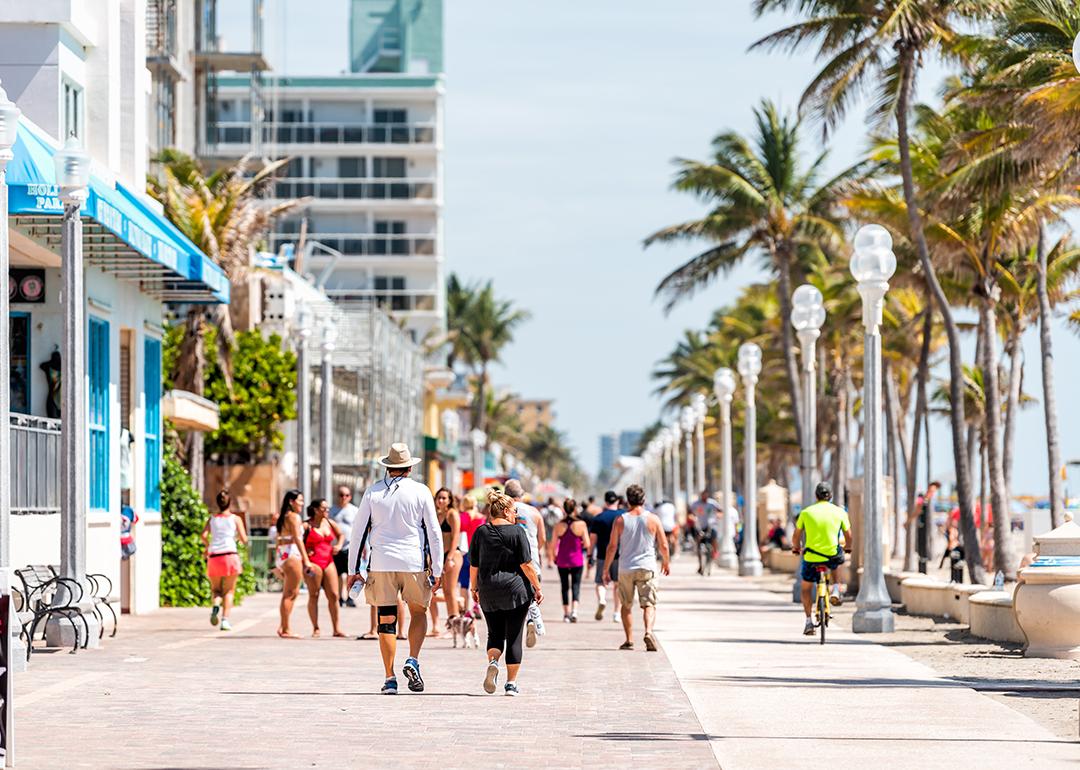 People along the beach boardwalk in Miami, Florida.