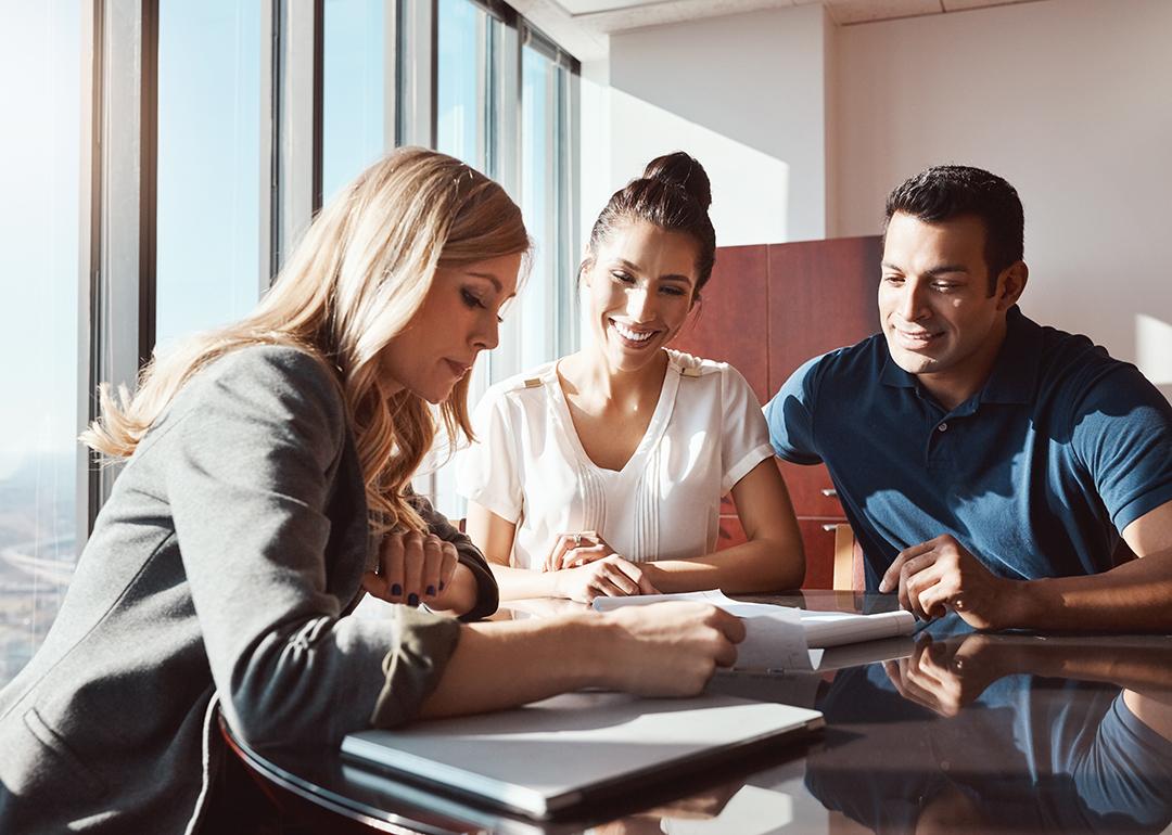 A couple engaging in a discussion with a financial advisor.