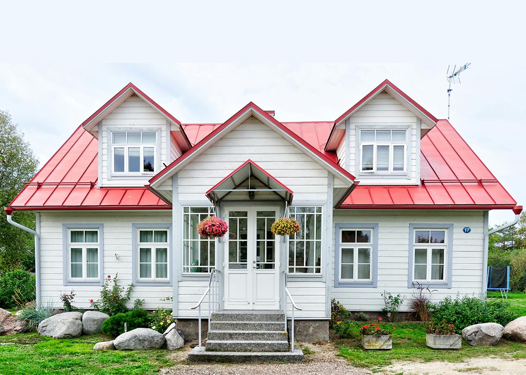 A large residential home with white and red exterior.