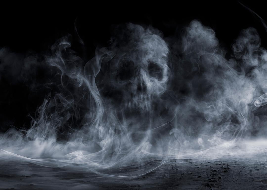 Fog forming a figure of a skull on dark background.