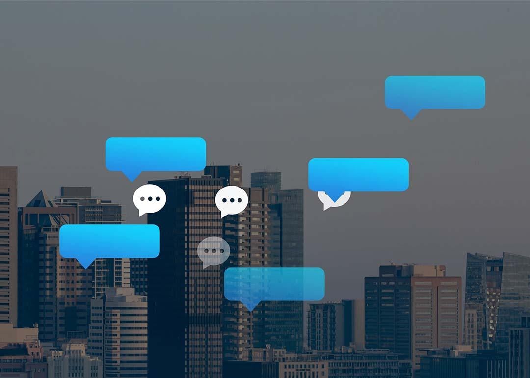 Vector chat and speech bubbles with a backdrop of city buildings.