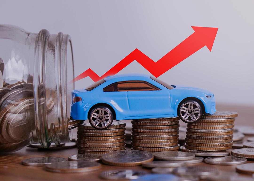 Increase price of car depicted by a small figure of a car over a stack of coins with a red upwards arrow.