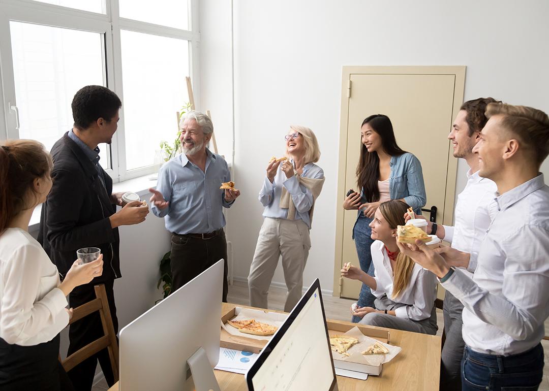A happy business team having pizza in their office.